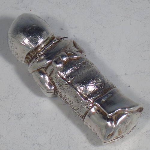 An Antique Victorian Sterling silver novelty scent bottle, in the shape of a baby in swaddling, and holding a babies rattle, with a hinged head and internal glass stopper. Made by Samson & Mordan of London in 1882. The dimensions of this fine hand-made antique silver scent bottle are length 7.5 cms (3 inches), width 2.5 cms (1 inch), and it weighs approx. 33g (1 troy ounce).