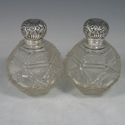 Antique Victorian sterling silver and hand-cut crystal pair of scent bottles, made by Edward Moses Levetus of Birmingham in 1892. Height 12 cms.