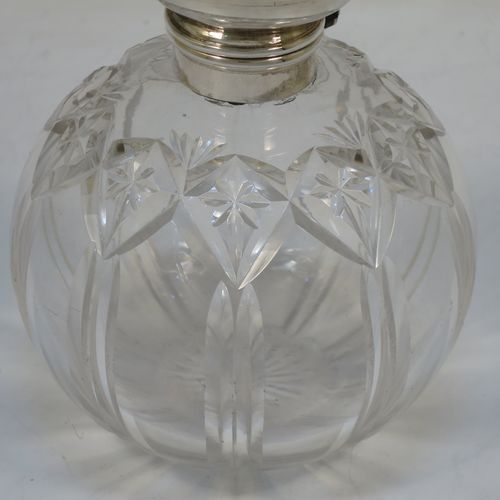 A very pretty Sterling Silver and inlaid tortoise-shell hand-cut crystal table scent bottle, having a plain round mount, a hinged lid with an inlaid  tortoise-shell cover, an internal stopper, and hand-cut main body with reeding and star-cut decoration. Made by Henry Miller of Birmingham in 1923. The dimensions of this fine hand-made silver and tortoise shell scent bottle are height 12.5 cms (5 inches), and diameter 9.5 cms (3.75 inches).  