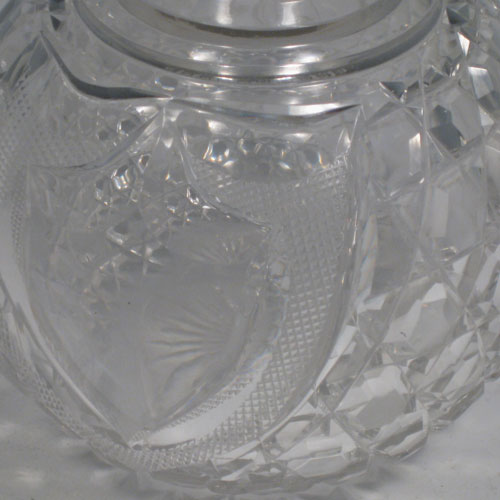 Antique Victorian sterling silver and hand-cut crystal large table scent bottle, having a hand-chased round mount with swirl-flute decoration, a hinged lid, an internal stopper, and hobnail cut main body with a shield-shaped cartouche. Made by James Dixon and Sons of Sheffield in 1901. The dimensions of this fine hand-made scent bottle are height 15 cms (6 inches), and diameter 11 cms (4.25 inches).   