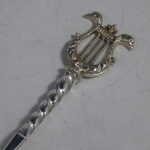 An Antique Victorian Sterling Silver and gold-gilt serving spoon set, consisting of a pair of serving spoons and a sugar sifting ladle, having cast handles with twisted stems and Lyre shaped terminals, and with gold-gilt bowls, and all sitting in an original olive green satin and velvet-lined presentation box. Made by Holland, Aldwinckle, & Slater of London in 1895. The dimensions of this fine hand-made set of antique silver serving spoons are length 17 cms (6.75 inches), and they weigh a total of approx. 154g (5 troy ounces).   