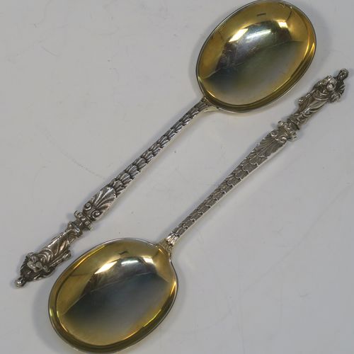 A beautiful pair of Antique Victorian Sterling Silver serving spoons, having cast handles with figural Apostle ends, and plain oval bowls with a gold-gilt wash. These beautiful silver serving spoons were made by the appropriately named Saint Arnaud Creake of Sheffield in 1901. The dimensions of this fine hand-made pair of antique silver serving spoons are length 20cms (8 inches), and they weigh a total of approx. 142g (4.6 troy ounces).   