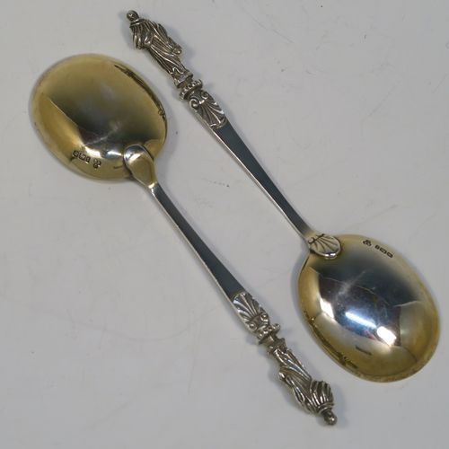 A beautiful pair of Antique Victorian Sterling Silver serving spoons, having cast handles with figural Apostle ends, and plain oval bowls with a gold-gilt wash. These beautiful silver serving spoons were made by the appropriately named Saint Arnaud Creake of Sheffield in 1901. The dimensions of this fine hand-made pair of antique silver serving spoons are length 20cms (8 inches), and they weigh a total of approx. 142g (4.6 troy ounces).   