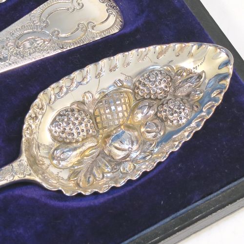 A very pretty set of four Antique Georgian Sterling Silver and gold-gilt berry serving spoons, having hand-chased handles with floral and scroll decoration, and gold-gilt hand-chased fluted bowls with fruit decoration, and all in a blue silk and velvet-lined presentation box. These beautiful antique silver serving spoons were made in London in 1802/03. The dimensions of this fine hand-made set of antique silver berry spoons are length 22.5cms (8.75 inches), and they weigh a total of approx. 213g (6.9 troy ounces).  