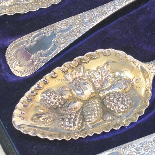 A very pretty set of four Antique Georgian Sterling Silver and gold-gilt berry serving spoons, having hand-chased handles with floral and scroll decoration, and gold-gilt hand-chased fluted bowls with fruit decoration, and all in a blue silk and velvet-lined presentation box. These beautiful antique silver serving spoons were made in London in 1802/03. The dimensions of this fine hand-made set of antique silver berry spoons are length 22.5cms (8.75 inches), and they weigh a total of approx. 213g (6.9 troy ounces).  