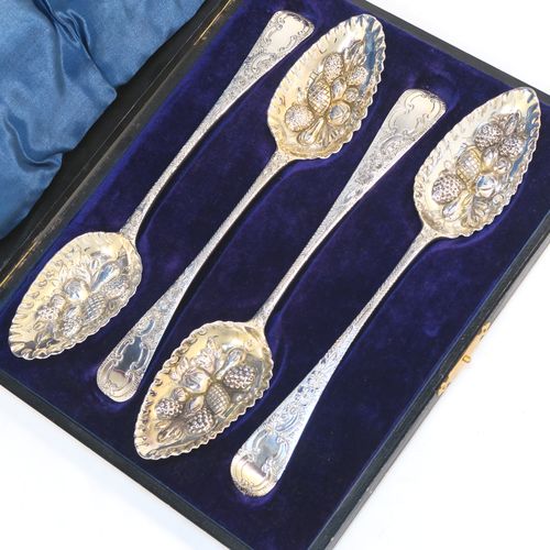 A very pretty set of four Antique Georgian Sterling Silver and gold-gilt berry serving spoons, having hand-chased handles with floral and scroll decoration, and gold-gilt hand-chased fluted bowls with fruit decoration, and all in a blue silk and velvet-lined presentation box. These beautiful antique silver serving spoons were made in London in 1802/03. The dimensions of this fine hand-made set of antique silver berry spoons are length 22.5cms (8.75 inches), and they weigh a total of approx. 213g (6.9 troy ounces).  