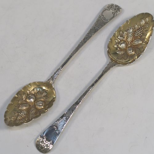 A very pretty pair of Antique Georgian Sterling Silver and gold-gilt berry serving spoons, having hand-chased handles with floral decoration, and gold-gilt hand-chased fluted bowls with fruit decoration, all in their original maroon satin and velvet-lined presentation box. These beautiful antique silver berry serving spoons were made by Josiah and George Piercy of London in 1819. The dimensions of this fine hand-made pair of antique silver berry spoons are length 23cms (9 inches), and they weigh a total of approx. 111g (3.6 troy ounces).   