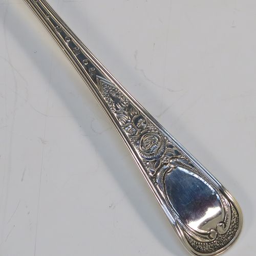 A very pretty pair of Antique Georgian Sterling Silver berry serving spoons, having hand-chased handles with floral decoration, and hand-chased gold-gilt bowls with fluted and fruit decoration, all in a cream satin and maroon velvet-lined presentation box. These beautiful silver serving spoons were made by Smith and Fern of London in 1795. The dimensions of this fine hand-made pair of antique silver berry spoons are length 22cms (8.75 inches), and they weigh a total of approx. 129g (4.2 troy ounces).   