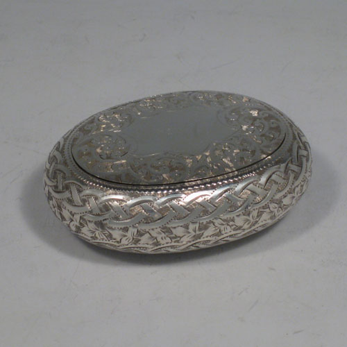    Antique Edwardian sterling silver squeeze-action tobacco box. Having an oval hand-engraved body and gold-gilt interior. Hallmarked for Birmingham in 1908. Length 8 cms (3 inches), width 6 cms (2.25 inches). Weight approx. 50g (1.6 troy ounces).