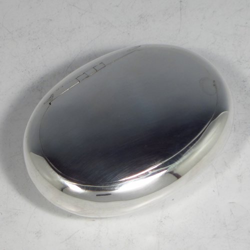 An Antique Victorian Sterling silver tobacco box, having a plain oval body, and squeeze-action sprung hinged lid. Made by Saunders & Shepherd of Birmingham in 1896. The dimensions of this fine hand-made silver tobacco box are length 8.5 cms (3.3 inches), depth 2.5 cms (1.0 inches), and it weighs approx. 75g (2.4 troy ounces).   