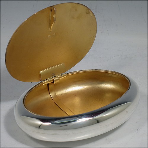 A large Antique Victorian Sterling Silver tobacco box, having a plain oval body with a gold-gilt interior, and squeeze-action sprung hinged lid with flat invisible hinge. Made by Horton & Allday of Birmingham in 1901. The dimensions of this fine hand-made antique silver tobacco box are length 11 cms (4.25 inches), width 8 cms (3.25 inches), depth 2.5 cms (1 inch), and it weighs approx. 119g (3.8 troy ounces).    