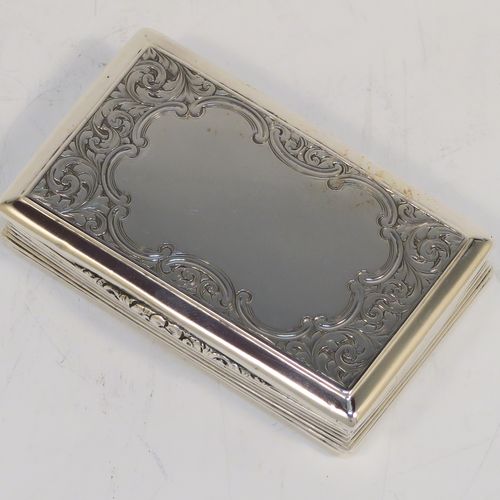 A beautiful Antique Victorian Sterling Silver snuff box, having a rectangular body with hand-engraved floral and scroll work, an applied cast foliate thumb-piece, and a gold-gilt interior. This elegant antique silver snuff box was made by Nathaniel Mills of Birmingham in 1850. The dimensions of this fine hand-made antique silver snuff box are length 7.5 cms (3 inches), width 4.5 cms (1.75 inches), depth 2 cms (0.6 inches), and it weighs approx. 69g (2.2 troy ounces).  