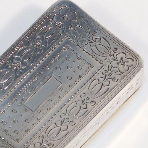 An elegant Antique Georgian Sterling Silver snuff box, having a rectangular body, with a slightly curved profile for holding in a waist-coat pocket, with hand-engraved geometrical & floral decoration, with a vacant rectangular cartouche on one side, a hinged lid and a gold-gilt interior. This beautiful antique silver snuff box was made by Joseph Willmore of Birmingham in 1826. The dimensions of this fine hand-made silver box are length 5.5 cms (2.25 inches), width 3.5 cms (1.3 inches), and it weighs approx. 27g (0.9 troy ounces).   