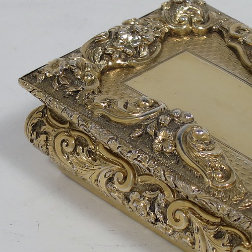 A rare and beautiful Antique Victorian Sterling Silver and gold-gilt large and heavy snuff box, having a rectangular body with applied cast foliate borders, a hinged lid with an applied panel with foliate border and vacant cartouche, the base with an applied panel having hand-engraved foliate & geometrical decoration, the sides with hand-chased floral work. Made by Fredrick Marson of Birmingham in 1848. The dimensions of this fine hand-made antique silver snuff box are length 9 cms (3.5 inches), width 6 cms (2.3 inches), depth 3 cms (1.25 inches), and it weighs approx. 167g (5.3 troy ounces).    