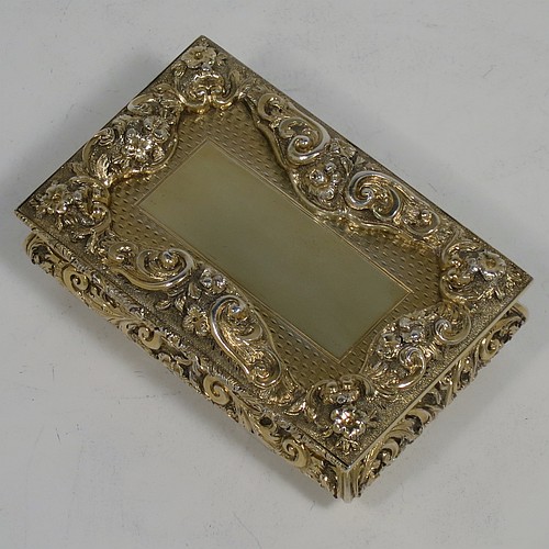 A rare and beautiful Antique Victorian Sterling Silver and gold-gilt large and heavy snuff box, having a rectangular body with applied cast foliate borders, a hinged lid with an applied panel with foliate border and vacant cartouche, the base with an applied panel having hand-engraved foliate & geometrical decoration, the sides with hand-chased floral work. Made by Fredrick Marson of Birmingham in 1848. The dimensions of this fine hand-made antique silver snuff box are length 9 cms (3.5 inches), width 6 cms (2.3 inches), depth 3 cms (1.25 inches), and it weighs approx. 167g (5.3 troy ounces).    