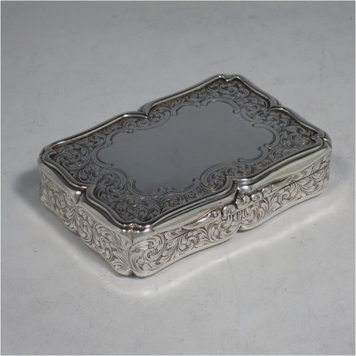 An Antique Victorian Sterling silver large snuff box, having a shaped rectangular body with hand-engraved floral work, an applied cast foliate thumb-piece, and a gold-gilt interior. Made by Nathaniel Mills of Birmingham in 1850. The dimensions of this fine hand-made antique silver snuff box are length 8.5 cms (3.3 inches), width 6 cms (2.3 inches), depth 2 cms (0.6 inches), and it weighs approx. 108g (3.5 troy ounces).   