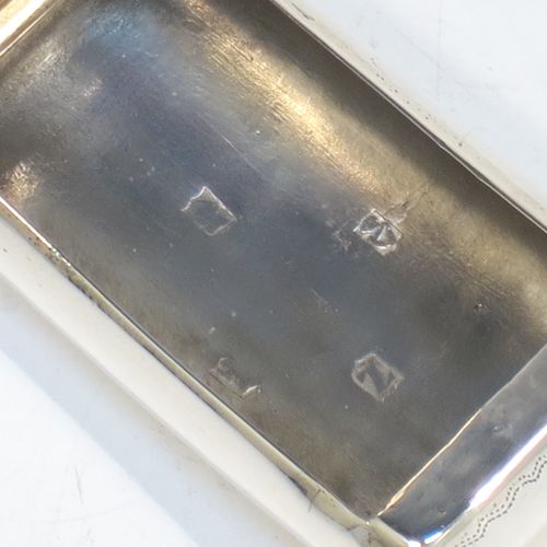 A rare and handsome Irish Antique Georgian Sterling Silver snuff box, having a rectangular body, with a slightly curved profile for holding in a waist-coat pocket, with hand-engraved geometrical & floral decoration, a vacant round cartouche on one side, and a flat invisibly hinged lid with thumb-piece. Made in Dublin, Ireland, in 1820. The dimensions of this fine hand-made antique Irish silver snuff box are length 5.5 cms (2.25 inches), width 3 cms (01.25 inches), and it weighs approx. 25g (0.8 troy ounces).   