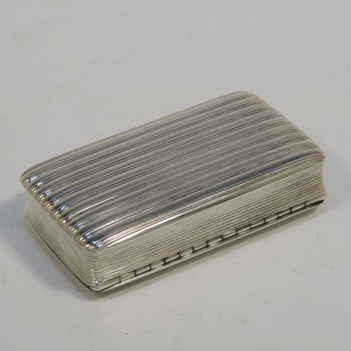 A very handsome Antique late Georgian Sterling Silver snuff box, having a rectangular body with hand-chased reeded decoration, a vacant rectangular cartouche on one side, and with a gold gilt interior. The dimensions of this fine hand-made antique silver snuff box are length 8cm (3 inches), width 4.5 cms (1.75 inches), depth 1.75 cms (0.7 inches), and it weighs approx. 92g (3 troy ounces).   