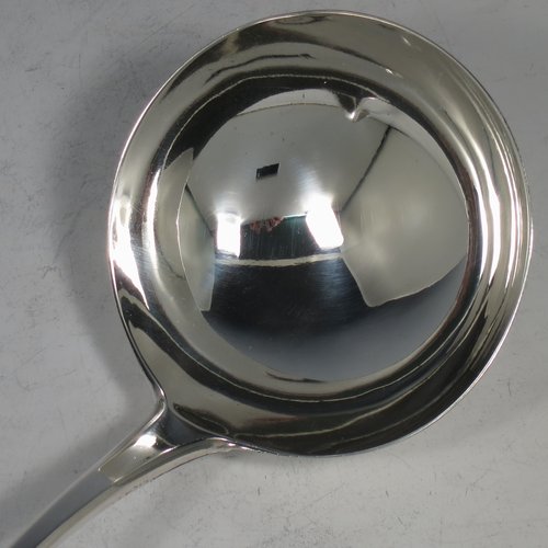 An Antique Georgian Sterling Silver soup ladle in the Old English pattern, having a plain handle with a pip on the reverse, and a plain round bowl with a heel on the reverse. Made by Peter & Anne Bateman of London in 1795. The dimensions of this fine hand-made silver soup ladle are length 34 cms (13.5 inches), and it weighs approx. 185g (6 troy ounces).   