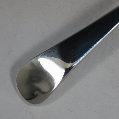 An Antique Georgian Sterling Silver soup ladle in the Old English pattern, having a plain handle with a pip on the reverse, and a plain round bowl with a heel on the reverse. Made by Peter & Anne Bateman of London in 1795. The dimensions of this fine hand-made silver soup ladle are length 34 cms (13.5 inches), and it weighs approx. 185g (6 troy ounces).   