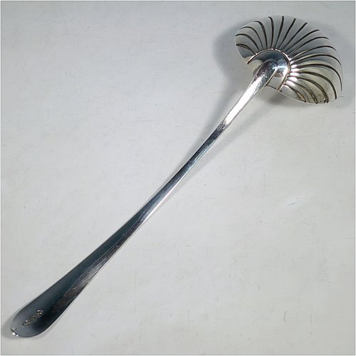 An Antique Georgian Sterling Silver large Irish soup ladle in the Irish Bright-Cut pattern, having a hand-engraved handle with bright-cut decoration, and a hand-chased shell style round bowl. Made in Dublin in 1794. The dimensions of this fine hand-made antique silver soup ladle are length 34 cms (13.3 inches), and it weighs approx. 159g (5.1 troy ounces). Please note that this item is crested.   