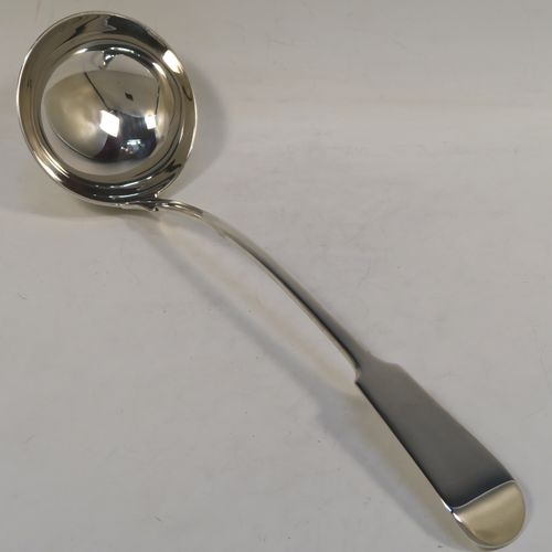 A very handsome Antique Scottish Georgian (William IV) Sterling Silver soup ladle in the Fiddle pattern, having a plain handle with a pip on the reverse, and a plain oval bowl with a heel on the reverse. This elegant antique silver soup ladle was made by James McKay of Edinburgh in 1836. The dimensions of this fine hand-made antique silver soup ladle are length 34.5 cms (13.5 inches), and it weighs approx. 248g (8 troy ounces).   