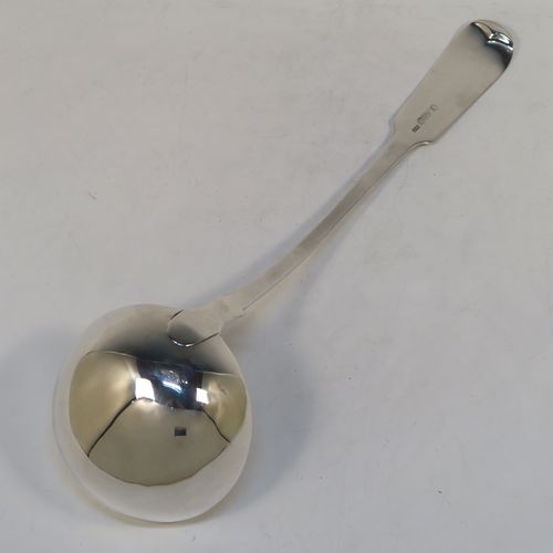 A very handsome Antique Scottish Georgian (William IV) Sterling Silver soup ladle in the Fiddle pattern, having a plain handle with a pip on the reverse, and a plain oval bowl with a heel on the reverse. This elegant antique silver soup ladle was made by James McKay of Edinburgh in 1836. The dimensions of this fine hand-made antique silver soup ladle are length 34.5 cms (13.5 inches), and it weighs approx. 248g (8 troy ounces).   