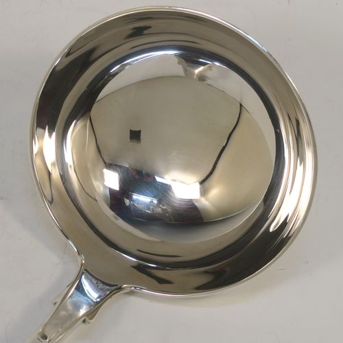 A very handsome Antique Scottish Georgian (William IV) Sterling Silver soup ladle in the Fiddle pattern, having a plain handle with a pip on the reverse, and a plain oval bowl with a heel on the reverse. This elegant antique silver soup ladle was made by James McKay of Edinburgh in 1836. The dimensions of this fine hand-made antique silver soup ladle are length 34.5 cms (13.5 inches), and it weighs approx. 248g (8 troy ounces).   