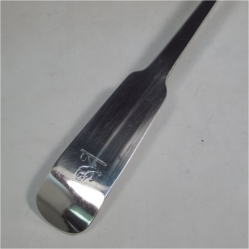 A rare Antique Georgian sterling silver Irish soup ladle in the Fiddle pattern, having a plain handle with a pip on the reverse, and a plain round bowl with shoulders above. Made in Dublin in 1781. The dimensions of this fine hand-made silver soup ladle are length 36.5 cms (14.3 inches), and it weighs approx. 191g (6.2 troy ounces). Please note that this item is crested.