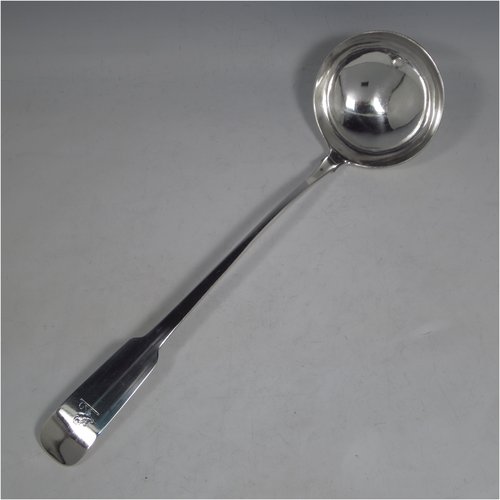 A rare Antique Georgian sterling silver Irish soup ladle in the Fiddle pattern, having a plain handle with a pip on the reverse, and a plain round bowl with shoulders above. Made in Dublin in 1781. The dimensions of this fine hand-made silver soup ladle are length 36.5 cms (14.3 inches), and it weighs approx. 191g (6.2 troy ounces). Please note that this item is crested.