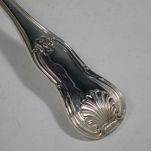 A very handsome and heavy Antique Georgian Sterling Silver soup ladle in the double-struck Kings Hourglass pattern, having a hand-chased shell and hour-glass on the handle, and a plain oval bowl with a shell on the reverse. Made by William Eley of London in 1828. The dimensions of this fine hand-made antique silver soup ladle are length 33 cms (13 inches), and it weighs approx. 270g (8.7 troy ounces).    