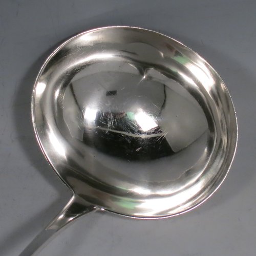 An Antique Georgian Sterling Silver soup ladle in the Old English pattern, having a plain handle with a pip on the reverse, and a plain round bowl. Made by Thomas Wallis II & Jonathan Hayne of London in 1813. The dimensions of this fine hand-made silver soup ladle are length 33 cms (13 inches), and it weighs approx. 168g (5.4 troy ounces).   