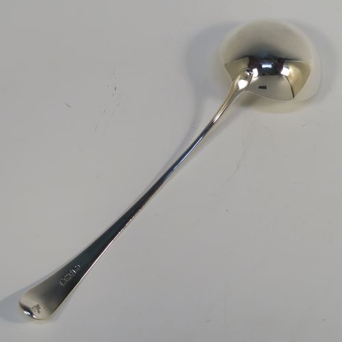 A handsome Antique Georgian Sterling Silver soup ladle in the Old English pattern, having a plain handle with a pip on the reverse, and a plain round bowl with a heel on the reverse. This elegant silver soup ladle was made by John Lambe of London in 1781. The dimensions of this fine hand-made antique silver soup ladle are length 33 cms (13 inches), and it weighs approx. 157g (5 troy ounces).   