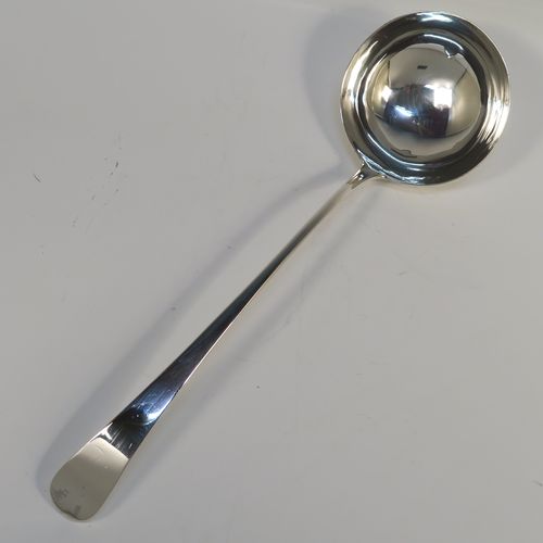 A handsome Antique Georgian Sterling Silver soup ladle in the Old English pattern, having a plain handle with a pip on the reverse, and a plain round bowl with a heel on the reverse. This elegant silver soup ladle was made by John Lambe of London in 1781. The dimensions of this fine hand-made antique silver soup ladle are length 33 cms (13 inches), and it weighs approx. 157g (5 troy ounces).   