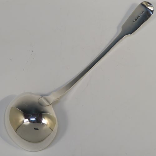 A heavy and elegant Antique Victorian Sterling Silver soup ladle in the Fiddle pattern, having a plain handle with a pip on the reverse, and a plain round bowl with shoulders above and a heel on the reverse. This handsome silver soup ladle was made by William Smiley of London in 1851. The dimensions of this fine hand-made antique silver soup ladle are length 36.5 cms (14.3 inches), and it weighs approx. 300g (9.7 troy ounces).   