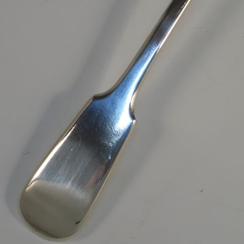 A heavy and elegant Antique Victorian Sterling Silver soup ladle in the Fiddle pattern, having a plain handle with a pip on the reverse, and a plain round bowl with shoulders above and a heel on the reverse. This handsome silver soup ladle was made by William Smiley of London in 1851. The dimensions of this fine hand-made antique silver soup ladle are length 36.5 cms (14.3 inches), and it weighs approx. 300g (9.7 troy ounces).   