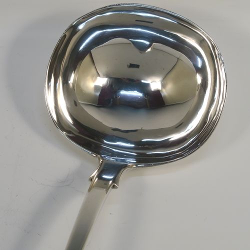 A heavy and elegant Antique Victorian Sterling Silver soup ladle in the Fiddle pattern, having a plain handle with a pip on the reverse, and a plain round bowl with shoulders above and a heel on the reverse. This handsome silver soup ladle was made by William Smiley of London in 1851. The dimensions of this fine hand-made antique silver soup ladle are length 36.5 cms (14.3 inches), and it weighs approx. 300g (9.7 troy ounces).   