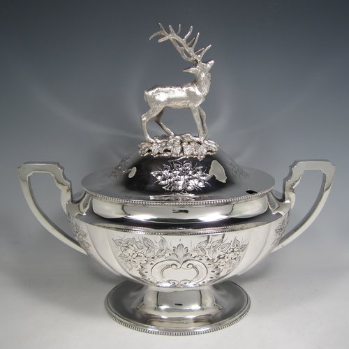 Antique Victorian silver plated soup tureen, having a pull-off lid with a cast model of a stag, with hand-chased floral decoration, applied bead-edged borders, two scroll side-handles, and all sitting on a pedestal foot. Made in ca. 1870. The dimensions of this fine hand-made silver-plated soup tureen and cover are height 33 cms (13 inches), length including handles 37 cms (14.5 inches), and width 20 cms (8 inches).   