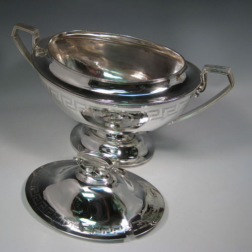 Antique Victorian sterling silver oval neoclassical style soup tureen and cover, with Greek-key style hand-engraving and reeded handles. Made by Walker & Hall of Sheffield in 1901. Height 33 cms (13 inches), length 46 cms (18 inches), width 23.5 cms (9.25 inches). Total weight approx. 91 troy ounces (2,281g).