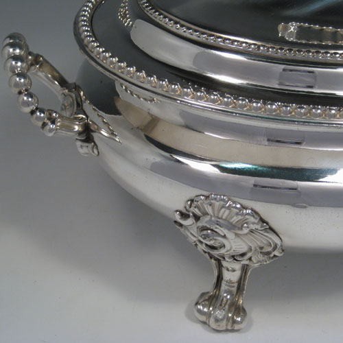 Antique Victorian silver plated oval soup tureen and cover with bead edges and handles, sitting on floral scroll feet. Made in ca. 1880. Height 25 cms (10 inches), length 38 cms (15 inches), width 25 cms (10 inches).