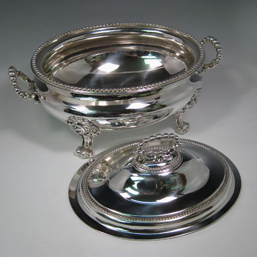 Antique Victorian silver plated oval soup tureen and cover with bead edges and handles, sitting on floral scroll feet. Made in ca. 1880. Height 25 cms (10 inches), length 38 cms (15 inches), width 25 cms (10 inches).