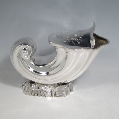 Antique Victorian silver plated spoon warmer, in the shape of a Cornucopia shell, having a hand-chased body with asymmetrical opening, a vacant cartouche with hand-engraved reed-work decoration, and all sitting on a cast rock base. Made by Henry Wilkinson of Sheffield in ca. 1880. The dimensions of this fine hand-made silver-plated spoon warmer are length 19 cms (7.5 inches), height 15 cms (6 inches), and width 10 cms (4 inches).   