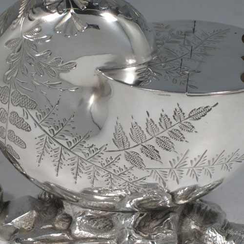 Antique Victorian silver plated spoon warmer, in the shape of a Nautilus shell, having hand-engraved fern-work decoration, a hinged lid, and cast rock base with shell thumb-piece. Made in ca. 1880 with a Victorian makers mark of AB * S. The dimensions of this fine hand-made silver-plated spoon warmer are length 16.5 cms (6.5 inches), height 14 cms (5.5 inches), and width 10 cms (4 inches).