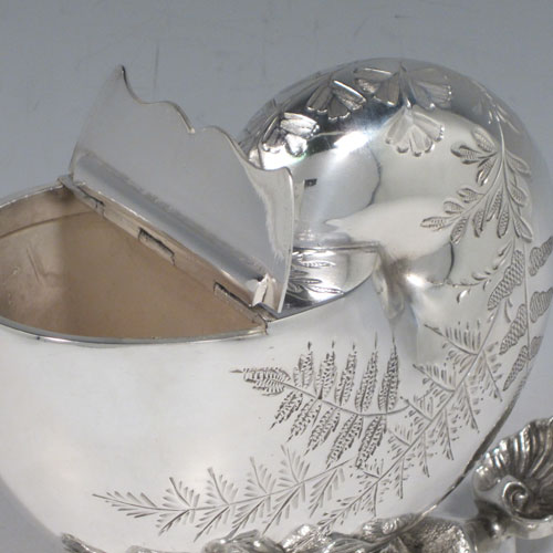 Antique Victorian silver plated spoon warmer, in the shape of a Nautilus shell, having hand-engraved fern-work decoration, a hinged lid, and cast rock base with shell thumb-piece. Made in ca. 1880 with a Victorian makers mark of AB * S. The dimensions of this fine hand-made silver-plated spoon warmer are length 16.5 cms (6.5 inches), height 14 cms (5.5 inches), and width 10 cms (4 inches).