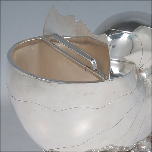 An Antique Victorian Silver Plated spoon warmer, in the shape of a Nautilus shell, having a hand-chased body with invisibly hinged lid opening, and all sitting on a cast rock base with shell thumb-piece. Made by the Atkin Brothers of Sheffield in ca. 1880. The dimensions of this fine hand-made silver-plated spoon warmer are length 16.5 cms (6.5 inches), height 14 cms (5.5 inches), and width 9 cms (3.5 inches).    