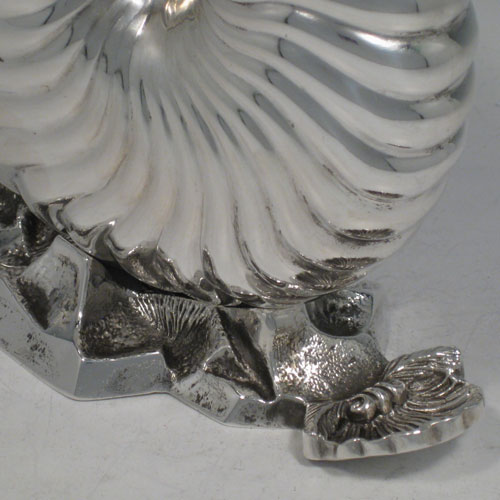 Antique Victorian silver plated spoon warmer, in the shape of a Nautilus shell, having a hinged lid, and cast rock base with shell thumb-piece. Made by Elkington and Co., with a manufacturing date letter for 1879. Length 15 cms (6 inches), height 13 cms (5.25 inches).