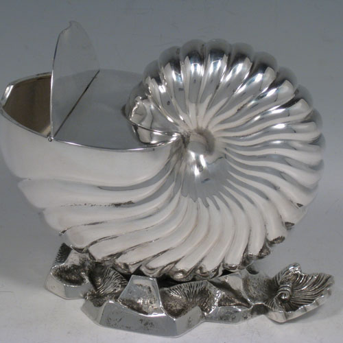 Antique Victorian silver plated spoon warmer, in the shape of a Nautilus shell, having a hinged lid, and cast rock base with shell thumb-piece. Made by Elkington and Co., with a manufacturing date letter for 1879. Length 15 cms (6 inches), height 13 cms (5.25 inches).