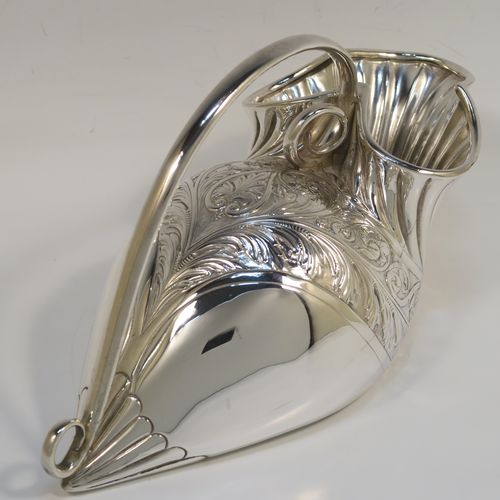 A beautiful and unusual Antique Victorian Silver Plated spoon warmer, in the shape of a fly trap pitcher plant, having a hand-chased body with fluted, leaf, and scroll decoration, and a scroll tendril handle. This pretty spoon warmer was made in ca. 1880 and has a design registration mark and a retailers mark for Glasgow. The dimensions of this fine hand-made antique silver-plated spoon warmer are length 20 cms (8 inches), height 10 cms (4 inches), and width 8.5 cms (3.3 inches).   