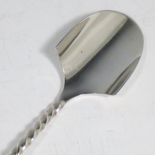 An Antique Victorian Sterling Silver and Ivory handled stilton cheese scoop, having a hand-cut spirally fluted handle, a hand-chased swirl-fluted ferrule, and a twisted stem with plain scoop. Made by William Hutton of London in 1899. The dimensions of this fine hand-made antique silver stilton cheese scoop are length 24 cms (9.5 inches).   