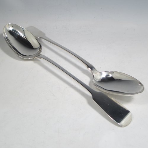 Antique late Georgian sterling silver pair of stuffing or basting spoons, in the Fiddle pattern, having plain oval pointed bowls, and plain long handles with pips on the reverse. Made by William Eley of London in 1830. The length of these fine hand-made silver basting / stuffing spoons is 30.5 cms (12 inches), and the total weight is approx. 224g (7.2 troy ounces).    